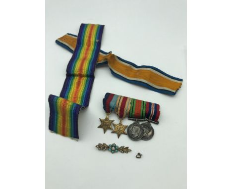 A Miniature set of WW2 Medals with two large additional ribbons and a gold coloured brooch set with turquoise and seed pearl 