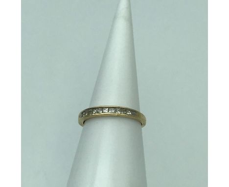 An 18ct gold ladies band ring set with square cut diamonds 10 in total. Ring size M, Weighs 1.64grams 