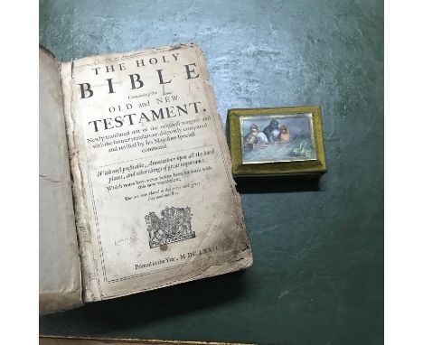 An old leather bound Holy Bible, together with an old trinket box with a printed panel depicting a bird and cricket scene