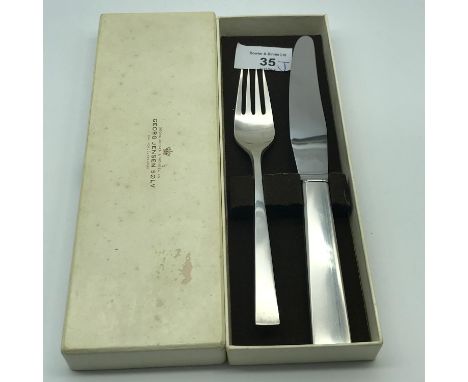 A Heavy Georg Jensen Sterling silver fork and Sterling silver handle knife. Comes with original presentation box.