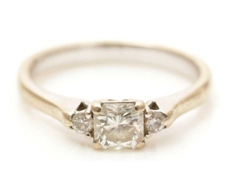 A three stone diamond ring, the principal asscher-cut diamond weighing approximately 0.65 carats, flanked by two brilliant cu