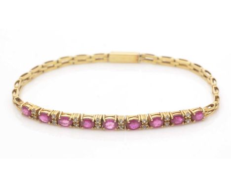 A ruby, white sapphire and yellow gold bracelet, set with nine oval facet-cut rubies parted by pairs of white-sapphires, flan