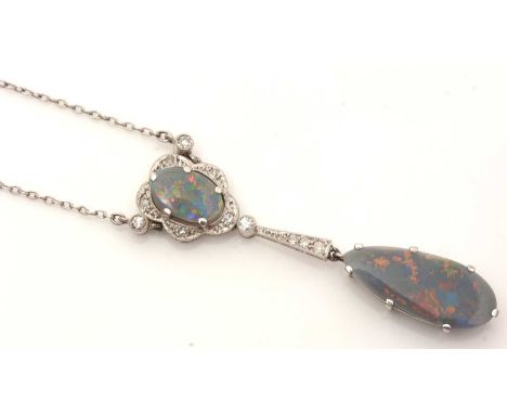 An Edwardian black opal and diamond pendant necklace, the oval black opal cabochon surrounded by eight-cut diamonds holding a