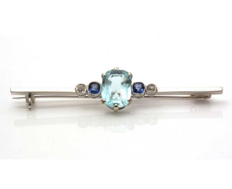 A paste, sapphire and diamond bar brooch, the oval light blue paste stone flanked by a pair of sapphires and diamonds, in 9ct