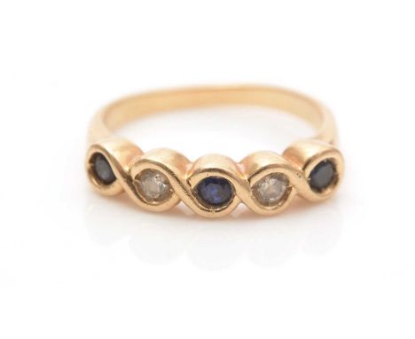 A sapphire and diamond ring, the circular facet-cut sapphires parted by brilliant-cut diamonds, in yellow gold twist mount an