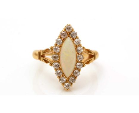 A Victorian opal and diamond cluster ring, the marquise-shaped opal cabochon surrounded by old-cut diamonds, on scrolling sho