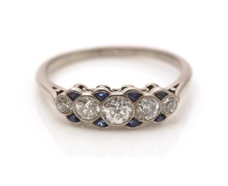 A sapphire and diamond ring, first quarter 20th Century, the five graduated transitional brilliant-cut diamonds weighing a to