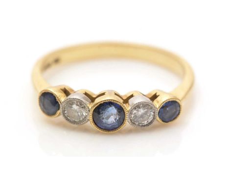 A sapphire and diamond ring, the circular facet cut sapphires parted by two brilliant-cut diamonds weighing a total of approx