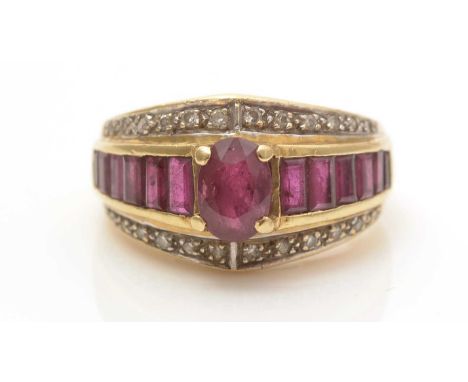 A ruby and diamond dress ring, centered by an oval facet-cut ruby flanked by further rectangular single-cut rubies, set above