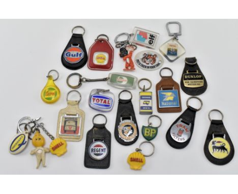 A mixed selection of vintage 20th century car key rings / chains or fobs. The selection includes a Tiger Esso example, Dunlop