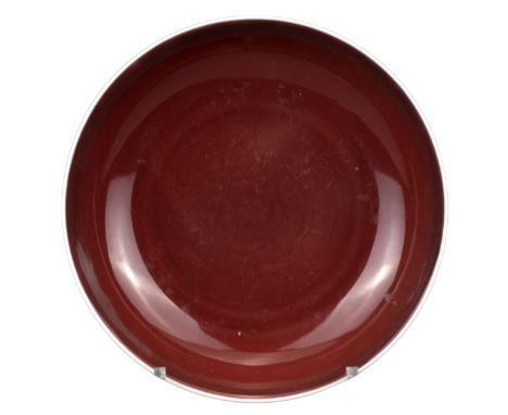 FINE CHINESE SANG DE BOEUF MONOCHROME PORCELAIN DISH, QIANLONG MARK AND PERIOD, 18th CENTURY  Covered in a deep red glaze sto