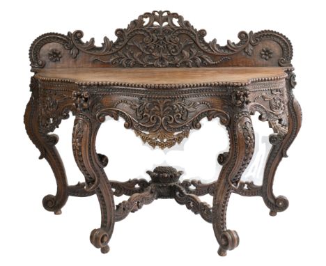ANGLO-INDIAN HARDWOOD CONSOLE TABLE, 19th CENTURY  The table on four legs profusely carved throughout with scrolling foliage 