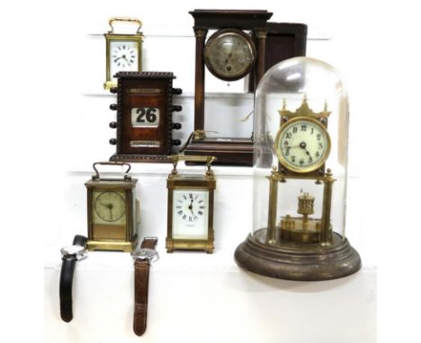 A tray of timepieces and clocks including a torsion clock under glass dome, portico mantel timepiece, a brass carriage clock 