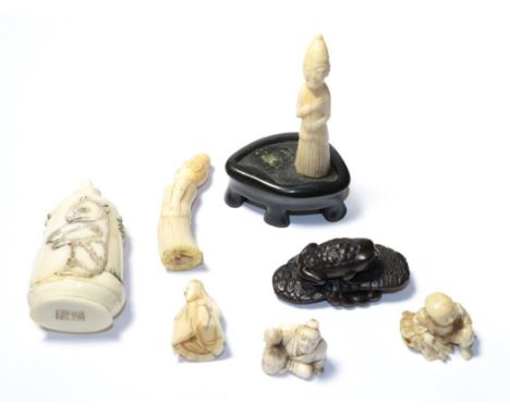 Two Japanese Meiji period carved ivory netsukes, a similar small carving, a modern bone scent bottle, a carved wood netsuke a