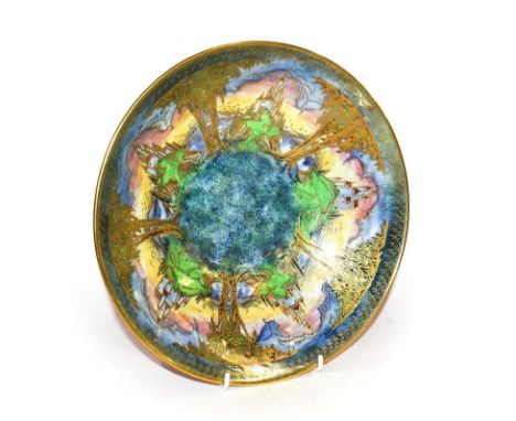 A Royal Worcester Crown Ware bowl, decorated with a coastal scene incorporating castles interspersed with trees, printed gilt