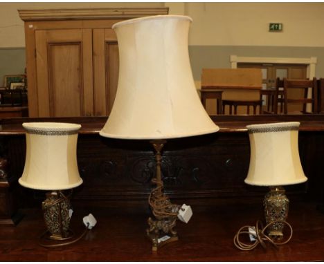 A Classical style gilt metal based table lamp raised on three paw feet, together with a pair of gilt metal square formed urn 