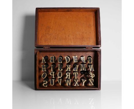 A set of brass alphabet bookbinder's lettering tools, 20th century, formed as 26 upper case letters, complete with full stop,