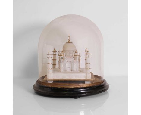 A carved alabaster model of the Taj Mahal, early 20th century, with enamelled and gilt detailing, under a glass dome, raised 