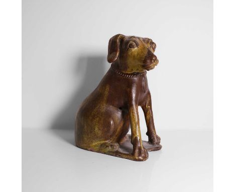 A glazed earthenware model of a dog, 18th/19th century, Indonesian, modelled in the folk art manner, with a brown and ochre g