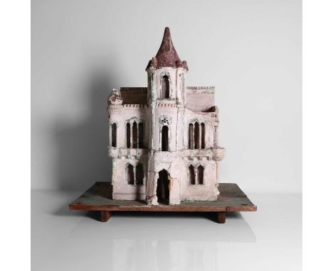 A folk art plaster model of a house, 19th century, Eastern European, with Moorish-style windows, with a central spired tower,