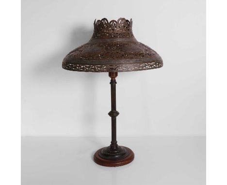 A Cairo ware pierced brass lamp, 19th century, decorated with six panels of Islamic script, mounted to an associated brass co