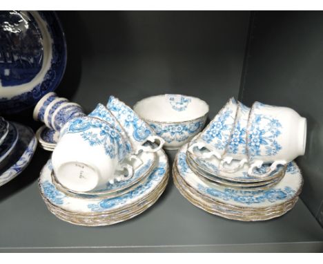 A selection of vintage tea cups and saucers with transfer print