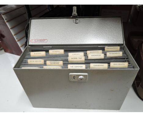 A vintage portable file case in metal shell with enamel finnish