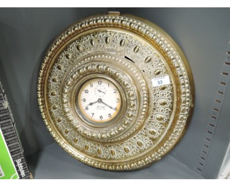 A vintage brass bodied wall mounted clock by Sewices Competitor