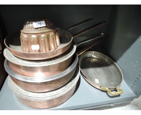 A selection of vintage copper and brass sauce pans and serving dishes
