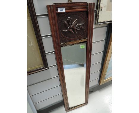 A vintage hall way mirror with carved frame and bevel edged glass