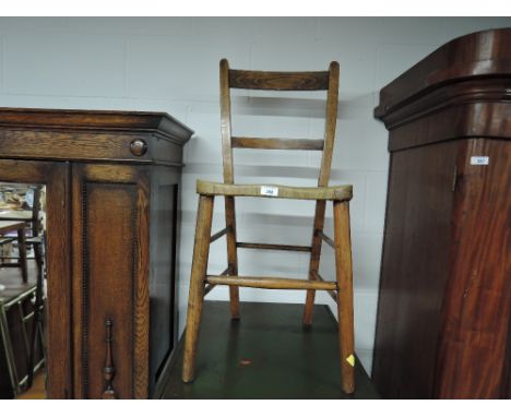 A traditional oak frame kitchen chair, with vintage faux seat