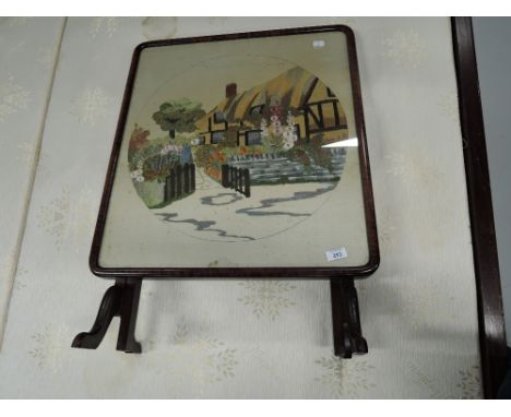 An embroidered folding table / firescreen