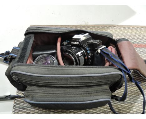 A Minolta 7000 Auto Focus camera and Minolta zoom lens with carry case etc