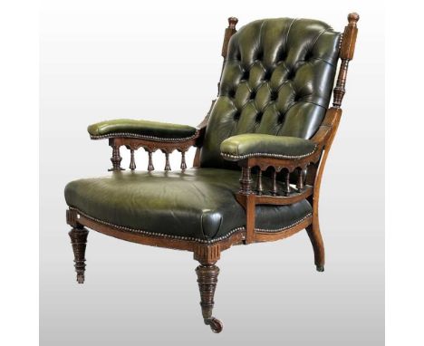A 19th century green leather upholstered button back arm chair, on turned legs