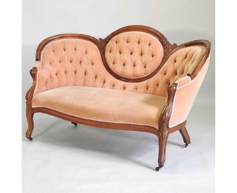 A Victorian peach upholstered button back show frame sofa, on cabriole legs152w x 77d x 91h cm