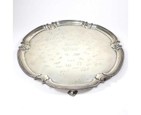 A mid 20th century silver salver, of circular shape, with a piecrust border, on shell feet, inscribed Wilkinson Sword, A J Pe