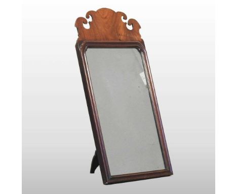 A George III walnut fret carved easel mirror, with a shaped cresting, 69 x 35cm
