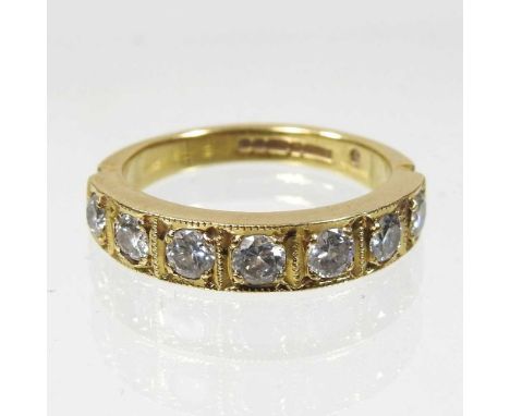 An 18 carat gold and diamond seven stone half hoop eternity ring, 5.8g, size Q