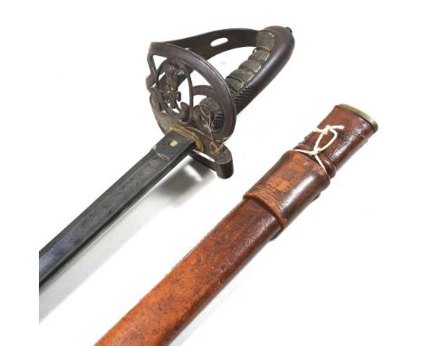 A Victorian military officer's dress sword, having a bound fishskin grip, with a pierced hilt and engraved steel blade, with 