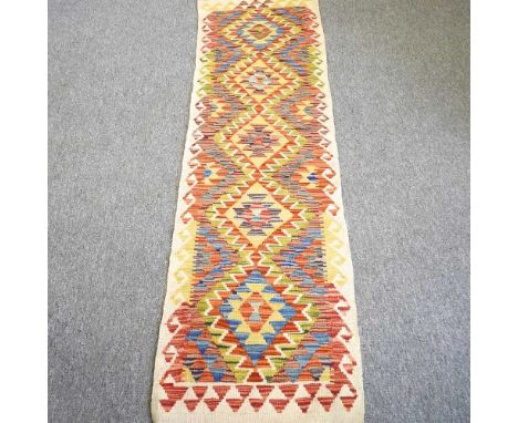 A kilim runner, with geometric design on a yellow ground, 195 x 56cm