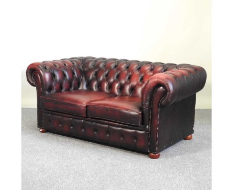 A red leather chesterfield sofa, with a button back164w x 96d x 75h cm