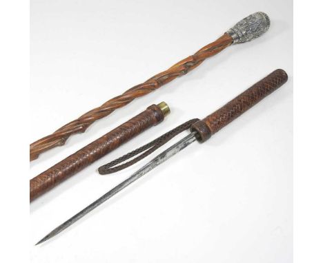 A 19th century walking cane, with a twisted shaft and embossed handle, 85cm long, together with a baton with a sword (2)Stick