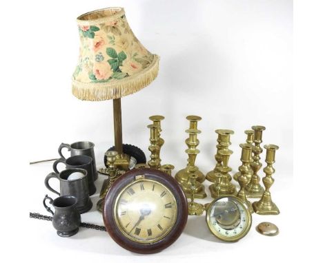 A collection of 19th century brass table candlesticks, a brass column table lamp, pewter mugs and clock parts