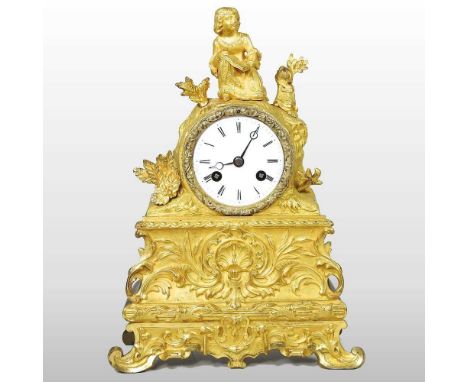 A 19th century French gilt spelter mantel clock, surmounted by a figure, 29cm high