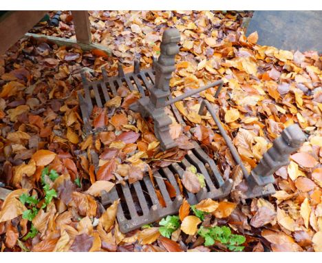 A CAST IRON FIRE GRATE ON DOGS.