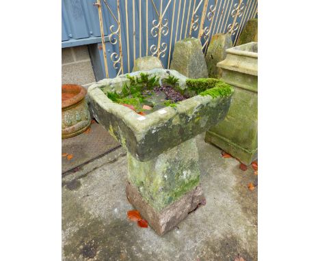 A SMALL STONE TROUGH ON STADDLE BASE.