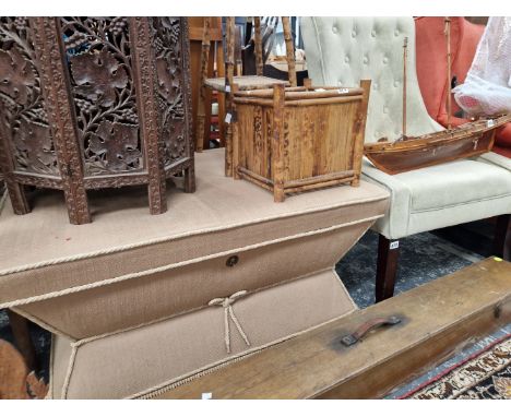 AN OTTOMAN AND A BUTTON BACK CHAIR.
