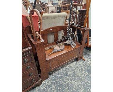 AN OAK HALL SET STICK STAND WITH VARIOUS WALKING STICKS.