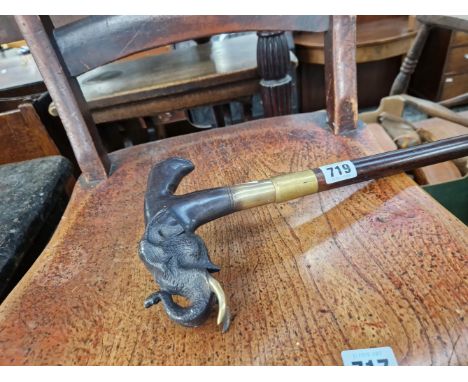 A BRONZE HANDLED WALKING CANE. 