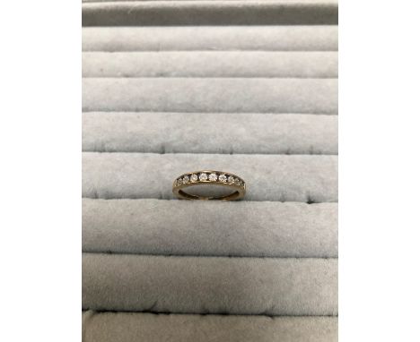 A 9ct HALLMARKED GOLD DIAMOND SET HALF ETERNITY CHANNEL SET RING. FINGER SIZE O 1/2. WEIGHT 1.97grms.